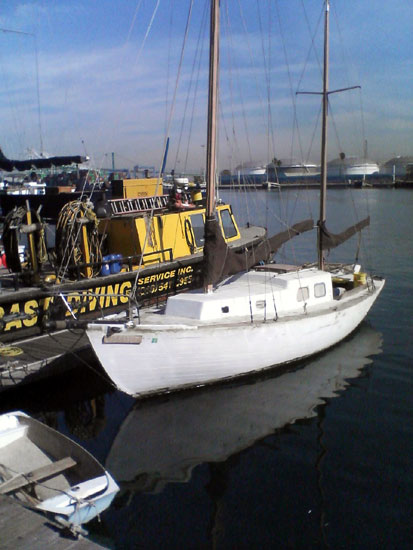 A white boat at a dock in San Pedro.