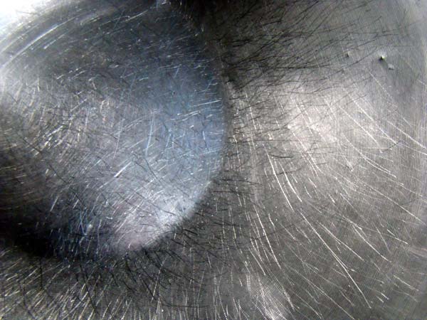 scratched surface of a stainless steel bowl